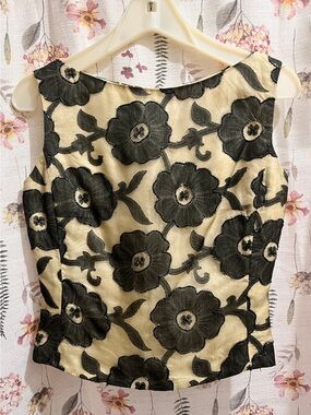 Sleeveless Cream Blouse with Black Floral Appliqué
